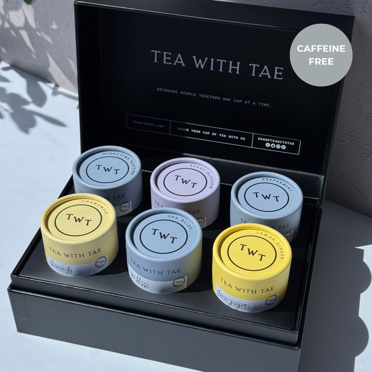 Image of the Tea with Tae Bento Box labeled “Caffeine Free,” featuring a black gift box with six assorted tea tubes.